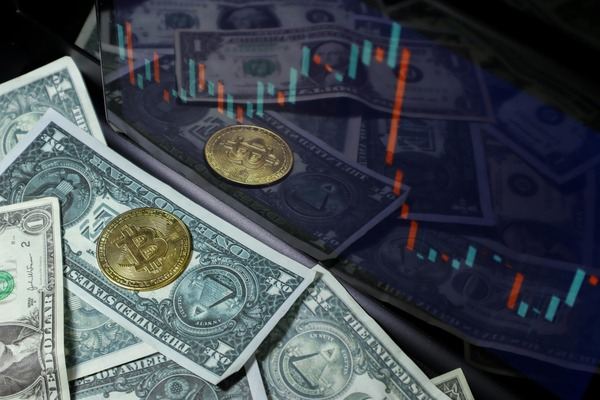 Bitcoin coins on US dollar bills under a glowing candlestick chart