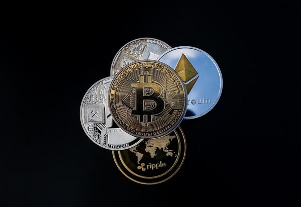Bitcoin, Ethereum and Ripple coins stacked on a black background