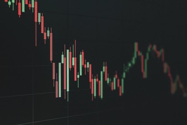 Red and green candlestick chart on a dark trading screen