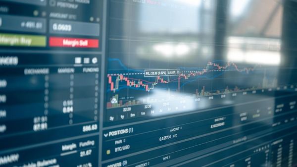 Blue trading terminal with price charts and order book