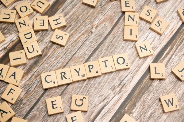 Wooden letter tiles spelling crypto on a wooden table